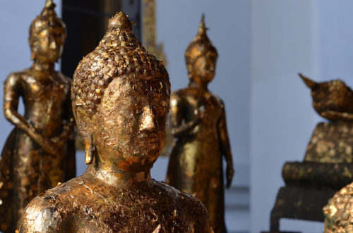Buddha statue covered in gold leaf, a traditional offering