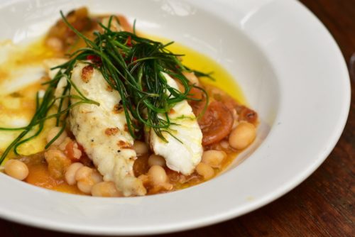 Chargrilled monkfish with Coco beans and tomatoes.