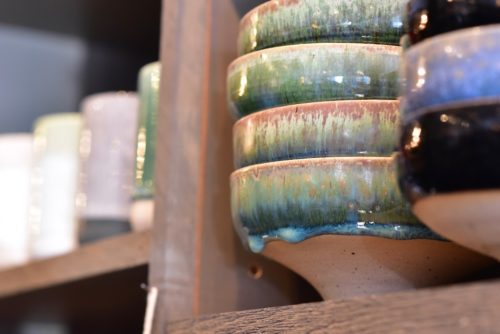 Locally made pottery adorns the shelves.